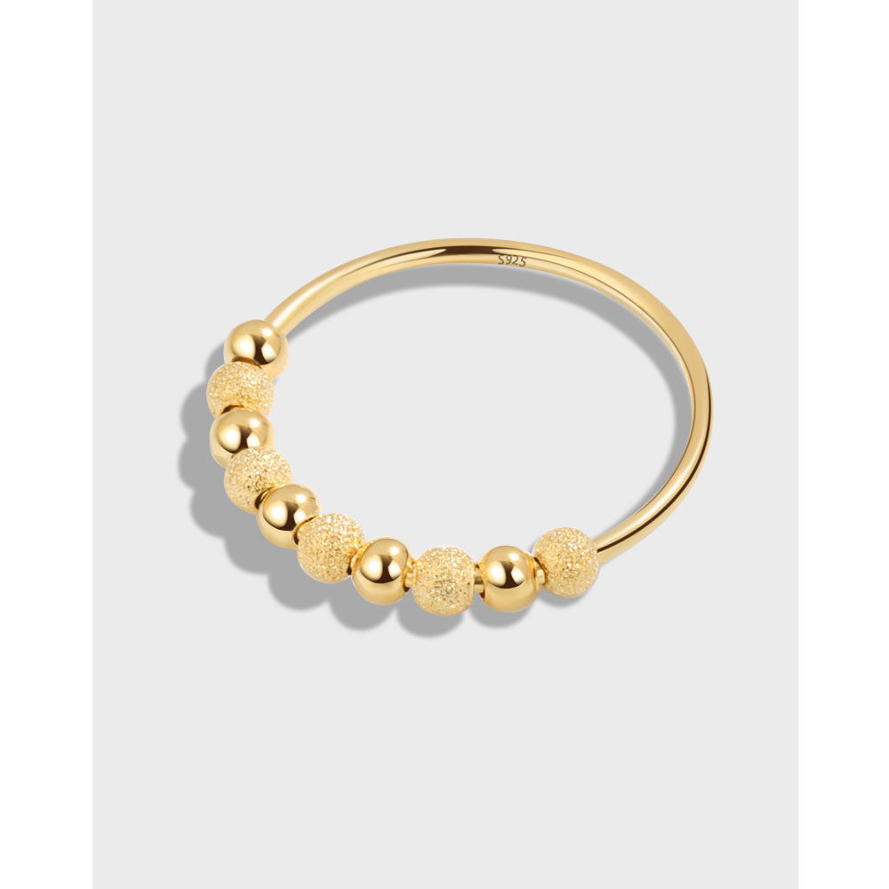 Velora Ring gold frosted rotation ring with alternating smooth and textured beads on a sleek band